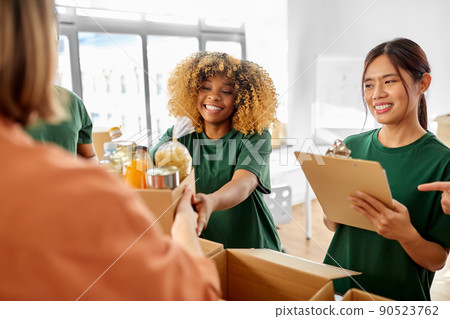 happy volunteers packing food in donation boxes 90523762