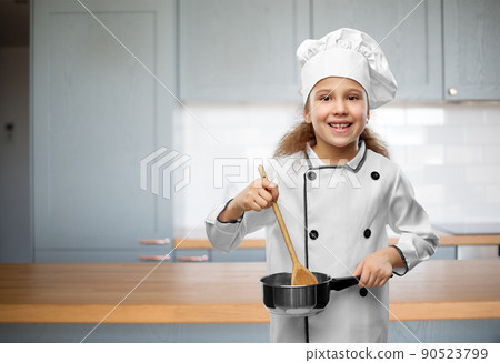 happy girl in chef's toque with spoon and saucepan 90523799
