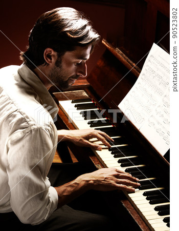 Making beautiful music. Profile of a handsome man playing the piano. 90523802
