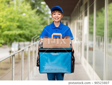 delivery woman with thermal insulated bag in city 90523807