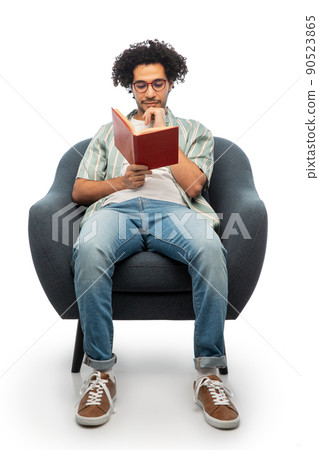 thinking man in glasses reading book in chair thinking man in glasses reading book in chair 90523865