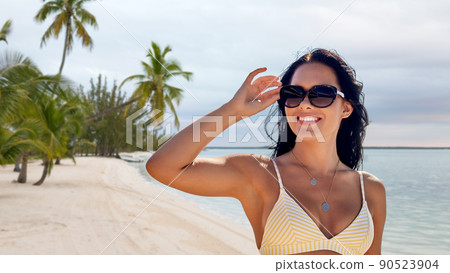 smiling young woman in sunglasses on summer beach smiling young woman in sunglasses on summer beach 90523904