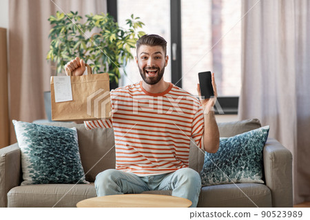 smiling man using smartphone for food delivery smiling man using smartphone for food delivery 90523989