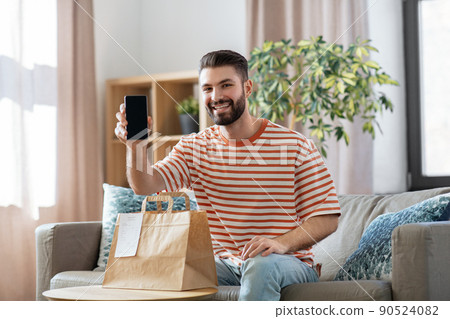 smiling man using smartphone for food delivery smiling man using smartphone for food delivery 90524082