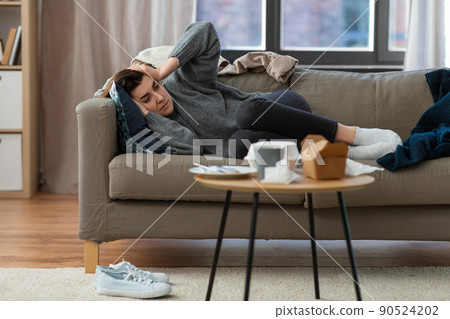 depressed woman lying on sofa at home depressed woman lying on sofa at home 90524202