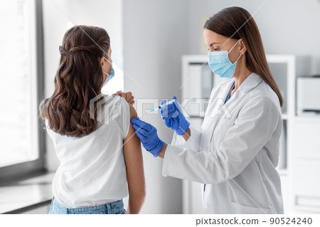 female doctor with syringe vaccinating patient female doctor with syringe vaccinating patient 90524240