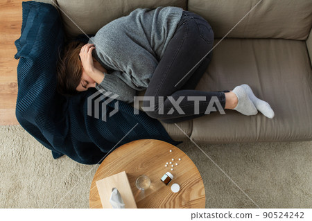 depressed woman lying on sofa at home depressed woman lying on sofa at home 90524242