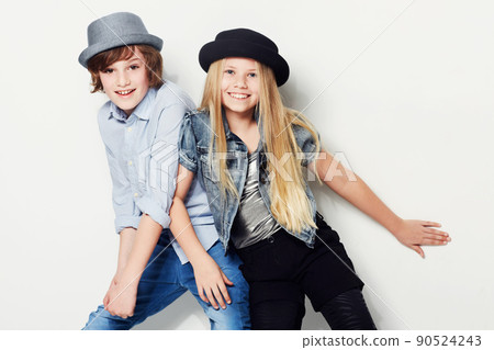Never too young to look trendy. Shot of two playful kids in a studio. Never too young to look trendy. Shot of two playful kids in a studio. 90524243