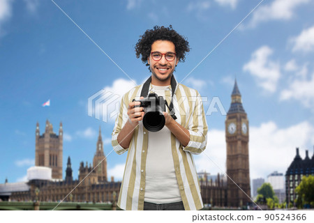 smiling man or photographer with camera in london 90524366
