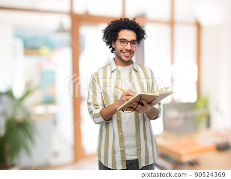 happy smiling man with diary and pencil at office happy smiling man with diary and pencil at office 90524369