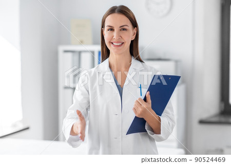 smiling female doctor with clipboard at hospital 90524469