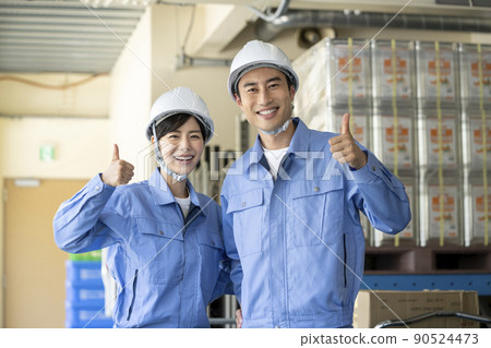 Image of work staff in the warehouse: Men and women with smiles wearing work clothes Image of work staff in the warehouse: Men and women with smiles wearing work clothes 90524473