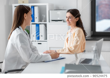 female doctor and woman patient meeting at clinic female doctor and woman patient meeting at clinic 90524475