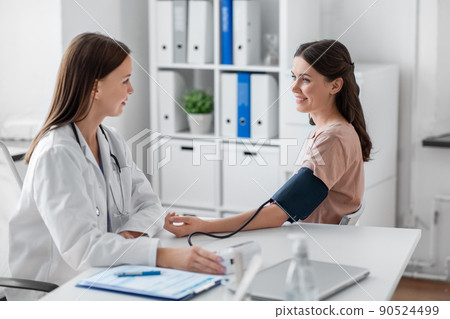 female doctor with tonometer and patient at clinic female doctor with tonometer and patient at clinic 90524499