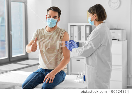 doctor applies patch to patient's hand at hospital doctor applies patch to patient's hand at hospital 90524554