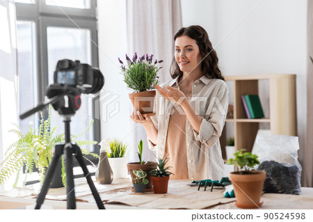 happy woman or blogger planting flowers at home happy woman or blogger planting flowers at home 90524598