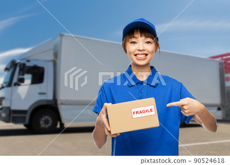 happy delivery woman holding parcel box over truck happy delivery woman holding parcel box over truck 90524618