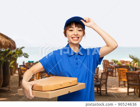 delivery woman with takeaway pizza boxes on beach delivery woman with takeaway pizza boxes on beach 90524636