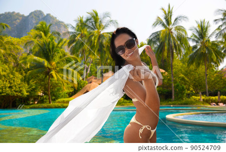 woman in bikini swimsuit with cover-up on beach woman in bikini swimsuit with cover-up on beach 90524709