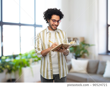 happy smiling man with diary and pencil at home happy smiling man with diary and pencil at home 90524721