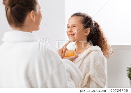 mother and daughter with moisturizer at bathroom mother and daughter with moisturizer at bathroom 90524766