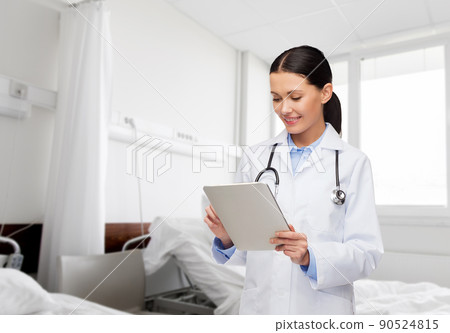 smiling female doctor with tablet pc in hospital smiling female doctor with tablet pc in hospital 90524815
