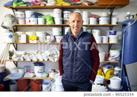 Hes ready to assist. Shot of a store owner standing in front of his merchandise. 90525334