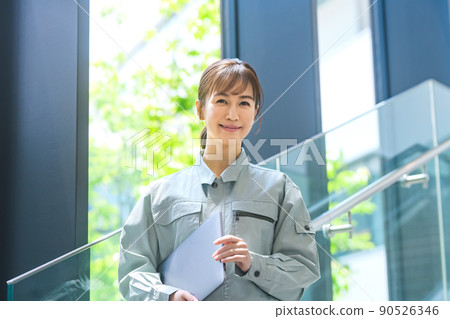 Young female engineer in work clothes with a computer working in the office Photographing cooperation: LINK FOREST Young female engineer in work clothes with a computer working in the office Photographing cooperation: LINK FOREST 90526346