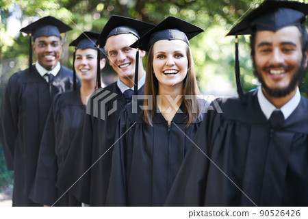 Theyre proud graduates. A group of happy students on graduation day. Theyre proud graduates. A group of happy students on graduation day. 90526426