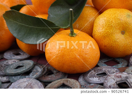 Mandarin oranges and ancient Chinese coins on bamboo background. Symbols of luck and Chinese New Year. Mandarin oranges and ancient Chinese coins on bamboo background. Symbols of luck and Chinese New Year. 90526741