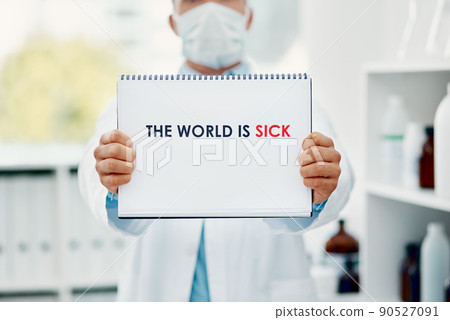 The world is not well. Shot of a scientist holding a sign with The world is sick on it in a laboratory. 90527091