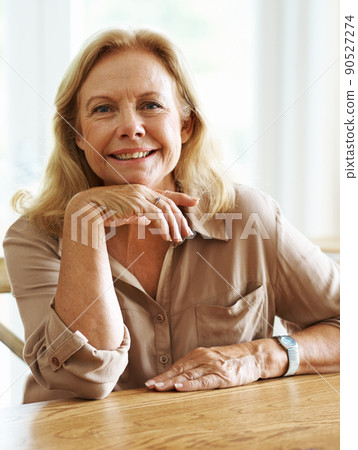 Life has been good to me. Portrait of a senior woman smiling at the camera while sitting indoors. Life has been good to me. Portrait of a senior woman smiling at the camera while sitting indoors. 90527274