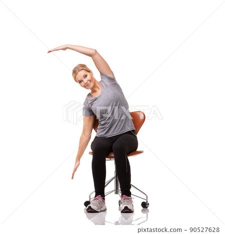 Perfect for your posture. Shot of a sporty woman doing stretches on a chair. Perfect for your posture. Shot of a sporty woman doing stretches on a chair. 90527628