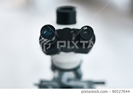 Place your eyes as close as you can. Still life shot of the eyepiece on a microscope in a laboratory. 90527644