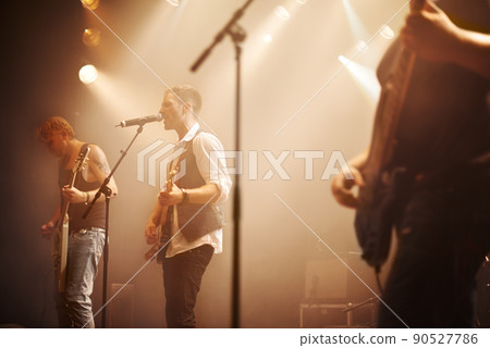 Moving you with their musical sound. Cropped shot of music performers on stage. 90527786