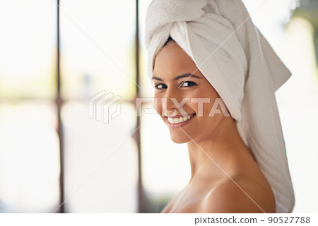 This spa day was a great idea. Shot of a young woman at the day spa. 90527788