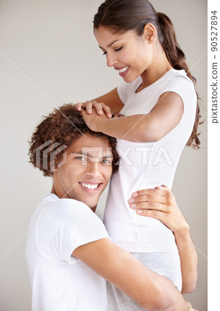 Shes the only one for me. A happy young ethnic couple embracing each other in a playful way. Shes the only one for me. A happy young ethnic couple embracing each other in a playful way. 90527894