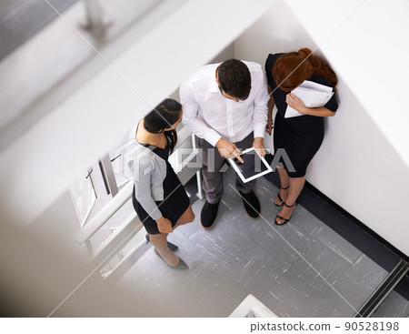 Quick brainstorm on the way to the meeting. Shot of a colleagues taking together in a stairwell. Quick brainstorm on the way to the meeting. Shot of a colleagues taking together in a stairwell. 90528198