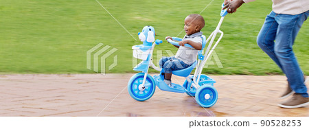 We must rediscover the magic all around us. Shot of a boy riding a bike in the park. 90528253