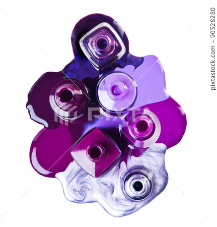 Purple is in this season. Studio shot of nail varnish with puddles around it. 90528280