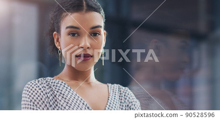 Confidence has taken me a long way. Cropped portrait of an attractive young businesswoman looking serious while standing in a modern office. 90528596