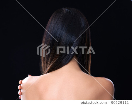 Raven haired beauty. Rearview studio shot of a model with beautiful brunette hair isolated on black. 90529111