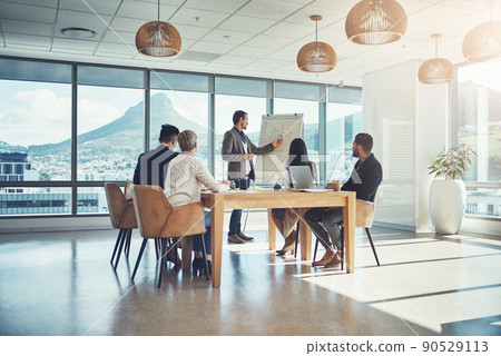 Creating a powerful action plan together. Shot of a businessman giving a presentation to his colleagues in an office. 90529113