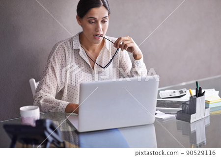 Solving the problem. Shot of a beautiful young business woman thinking at her desk. Solving the problem. Shot of a beautiful young business woman thinking at her desk. 90529116