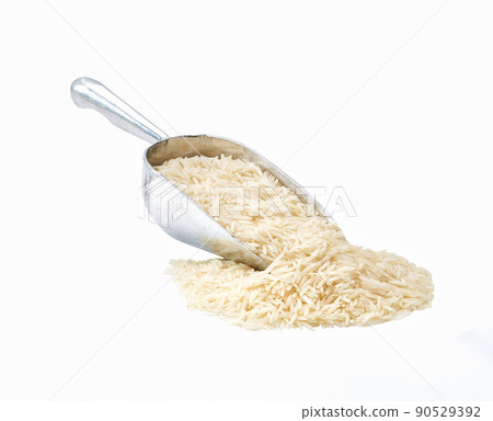 Small metal spoon or scoop with long rice basmati seen isolated on white background. Small metal spoon or scoop with long rice basmati seen isolated on white background. 90529392