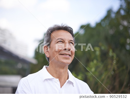 Getting some fresh air. Cropped shot of a handsome mature man standing outdoors. Getting some fresh air. Cropped shot of a handsome mature man standing outdoors. 90529532