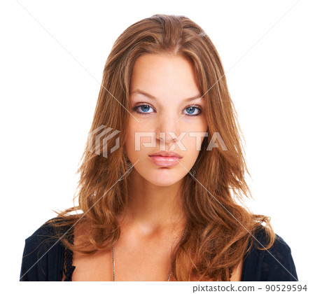 Young, proud and opinionated. Isolated portrait of a serious young woman staring at the camera, isolated on white. 90529594