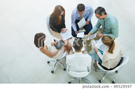 Meeting of creatives. High angle shot of a group of businesspeople meeting in the office. Meeting of creatives. High angle shot of a group of businesspeople meeting in the office. 90529597