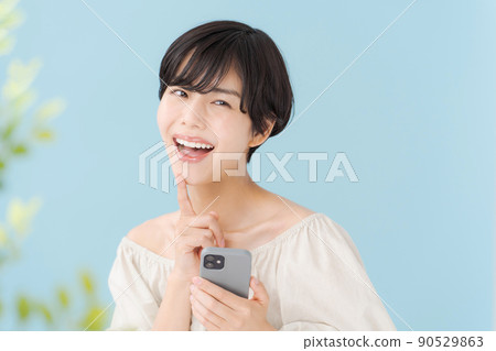A woman with a smartphone, light blue, blue 90529863