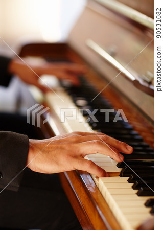 Showing masterly ability. Closeup shot of the hands of a man playing the piano. 90531082